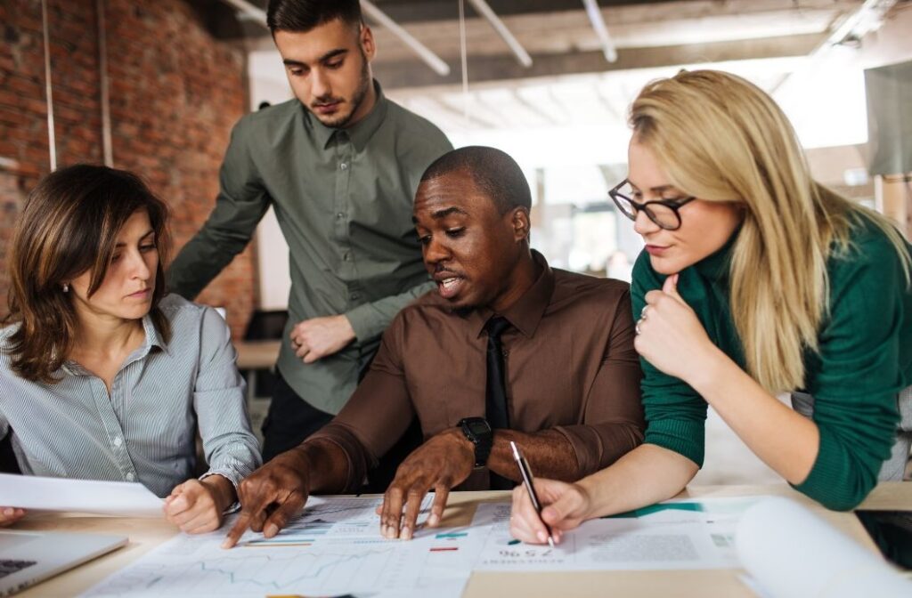 group of workers in an office having a group discussion