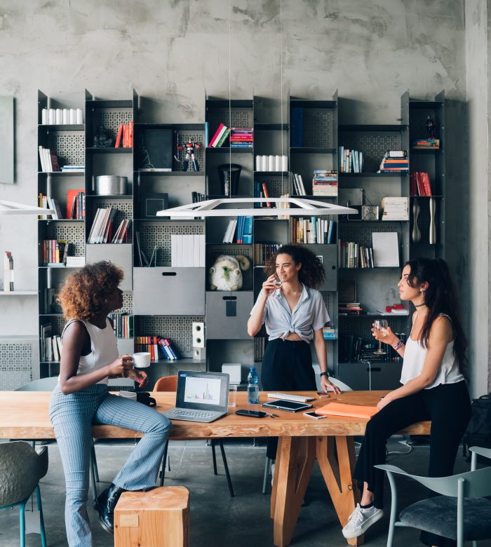 three young multiracial women having informal meeting in modern coworking office – interaction, creativity, resourceful